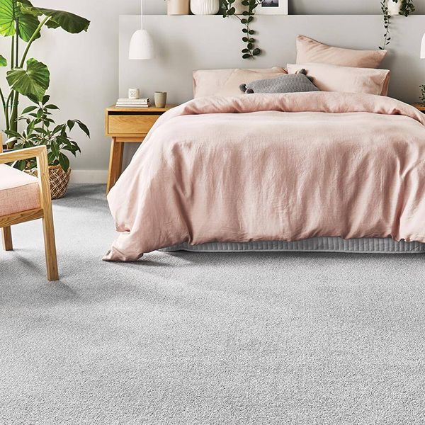Pink bedding on gray carpet
