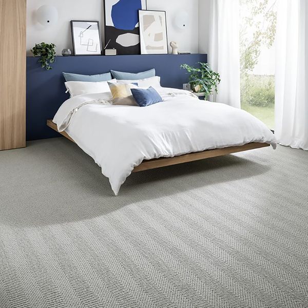 White bed on gray carpet