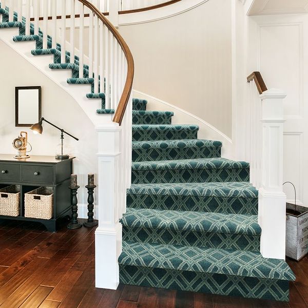 Green patterned carpet runner on curved staircase