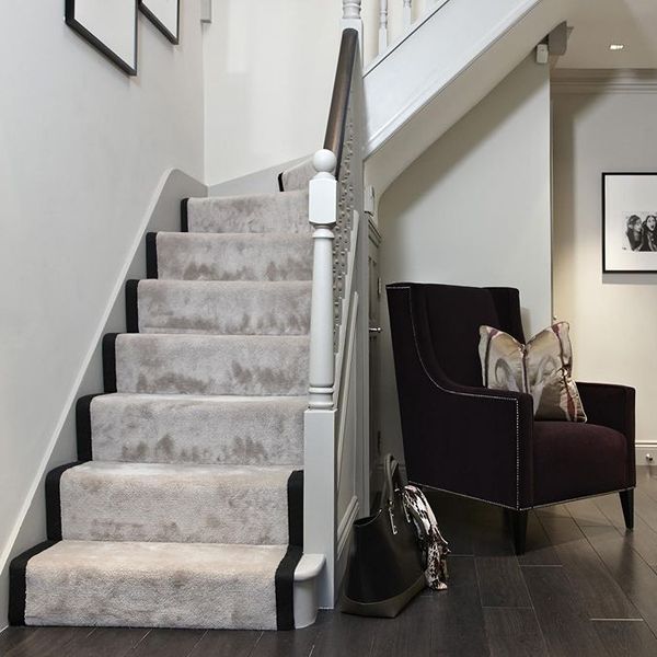 Light grey carpet runner installed on indoor staircase