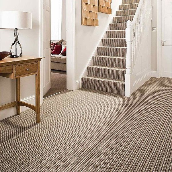 Neutral beige stair carpet runner on wooden staircase