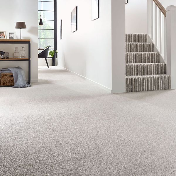 Bright hallway featuring wall to wall carpet